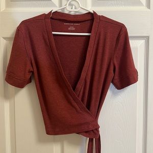American Eagle red wrap top. Button detail on the sleeves.
